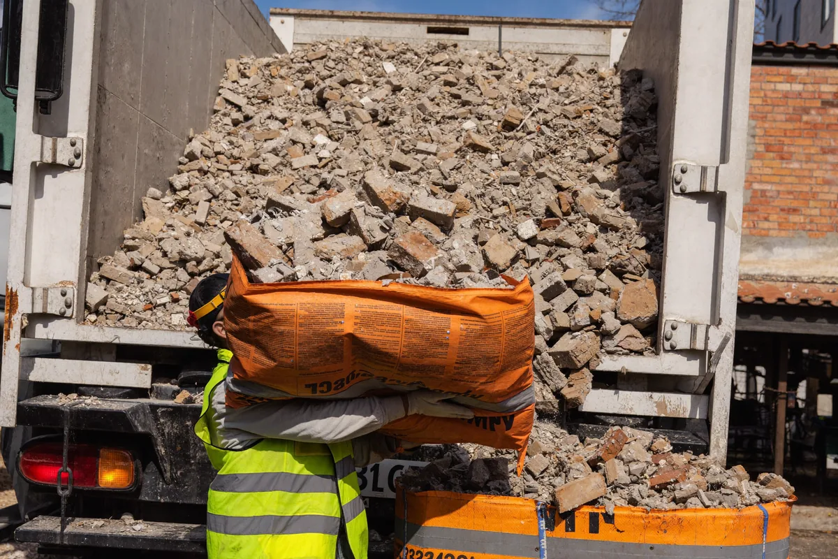 Builders waste and rubble being loaded into a Luton van for removal in London